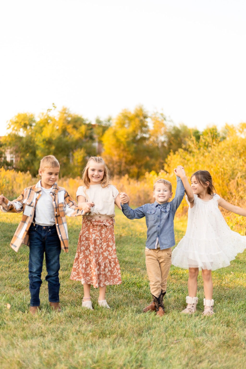 abby logan photo family swinging arms in park