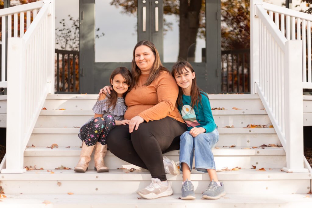 abby logan photo family posed on steps on fall day